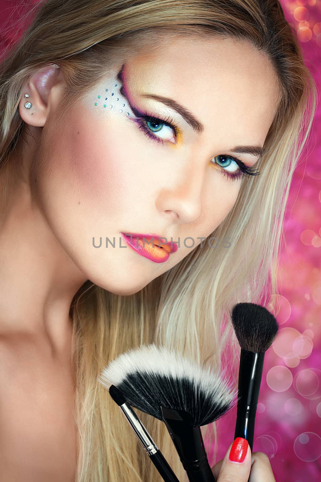 Girl holding make up brushes by oneinamillion