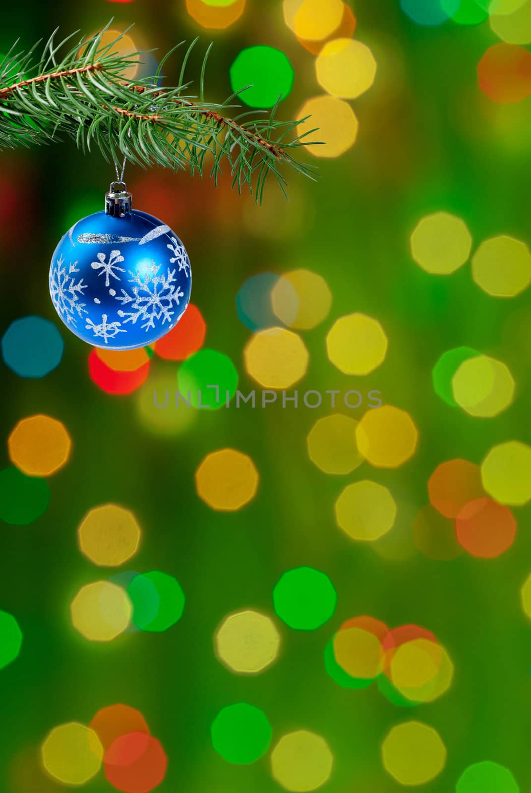 Green Christmas festive background with balls on green branch, place for holiday text