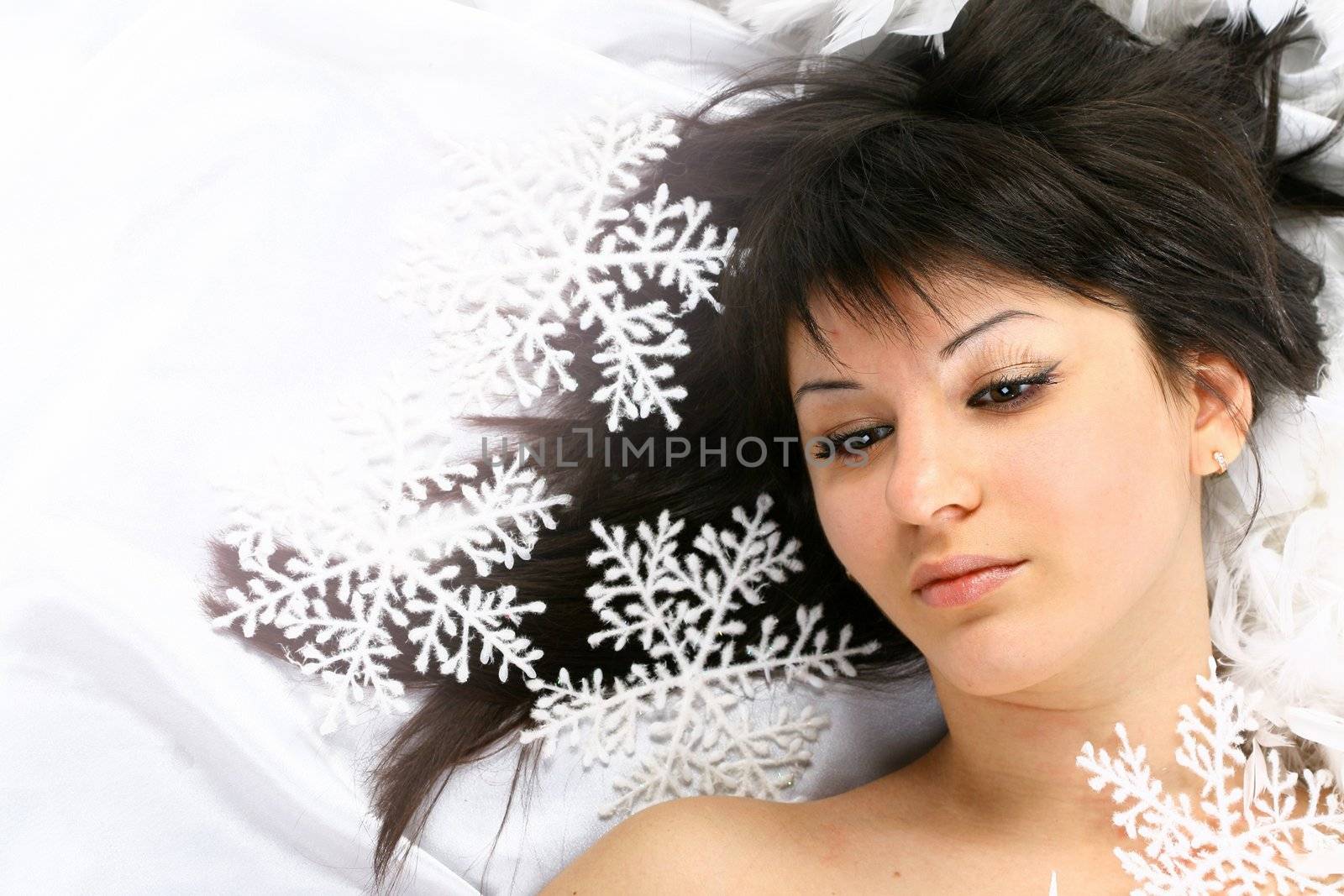 christmas girl Lays on white snowflakes fall on a head