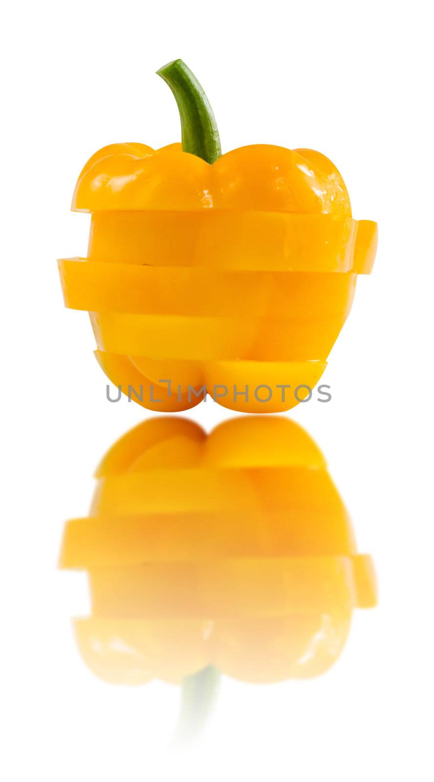 slice of yellow  bell pepper over  white background  with reflection