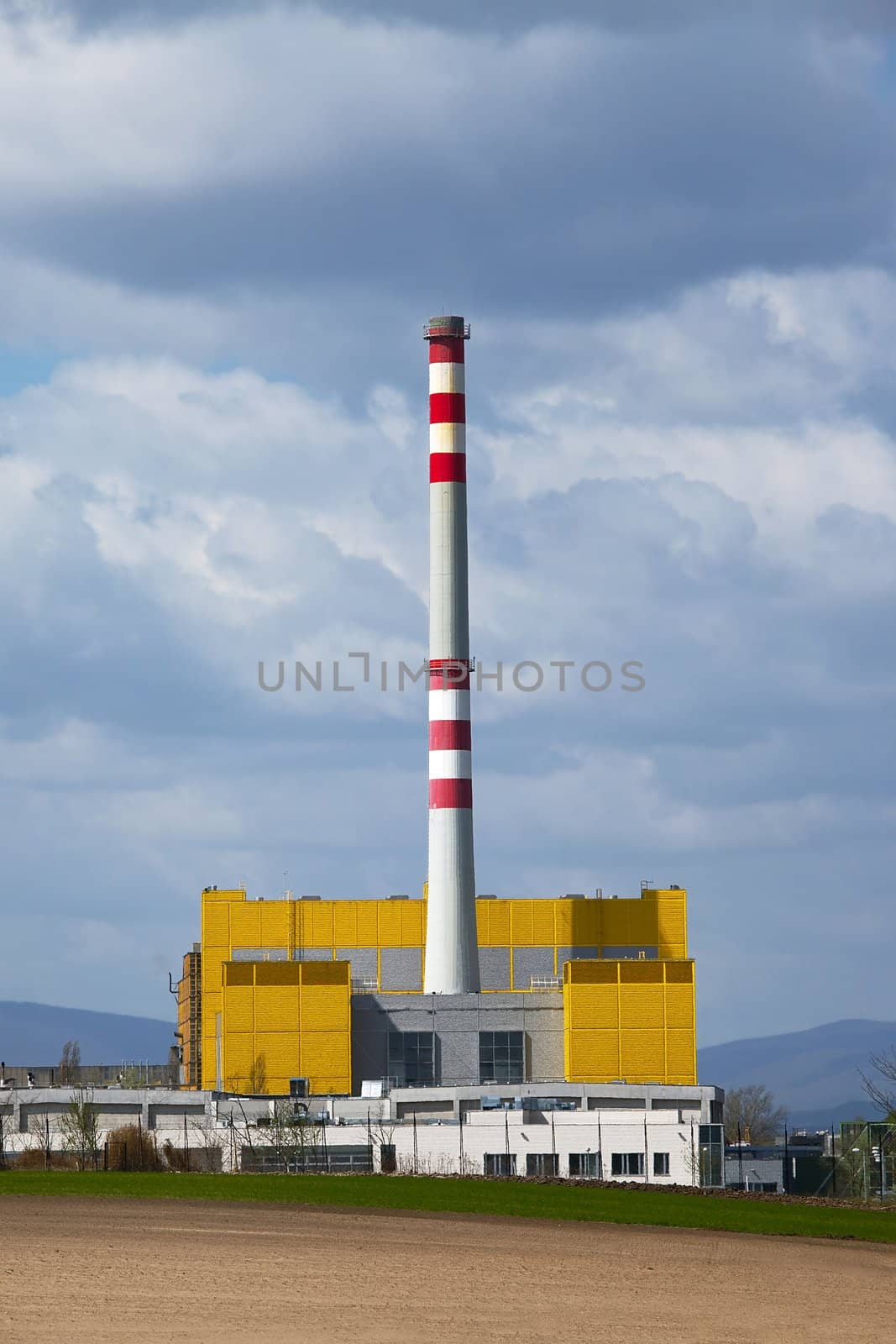 Industrial facility with tall chimney