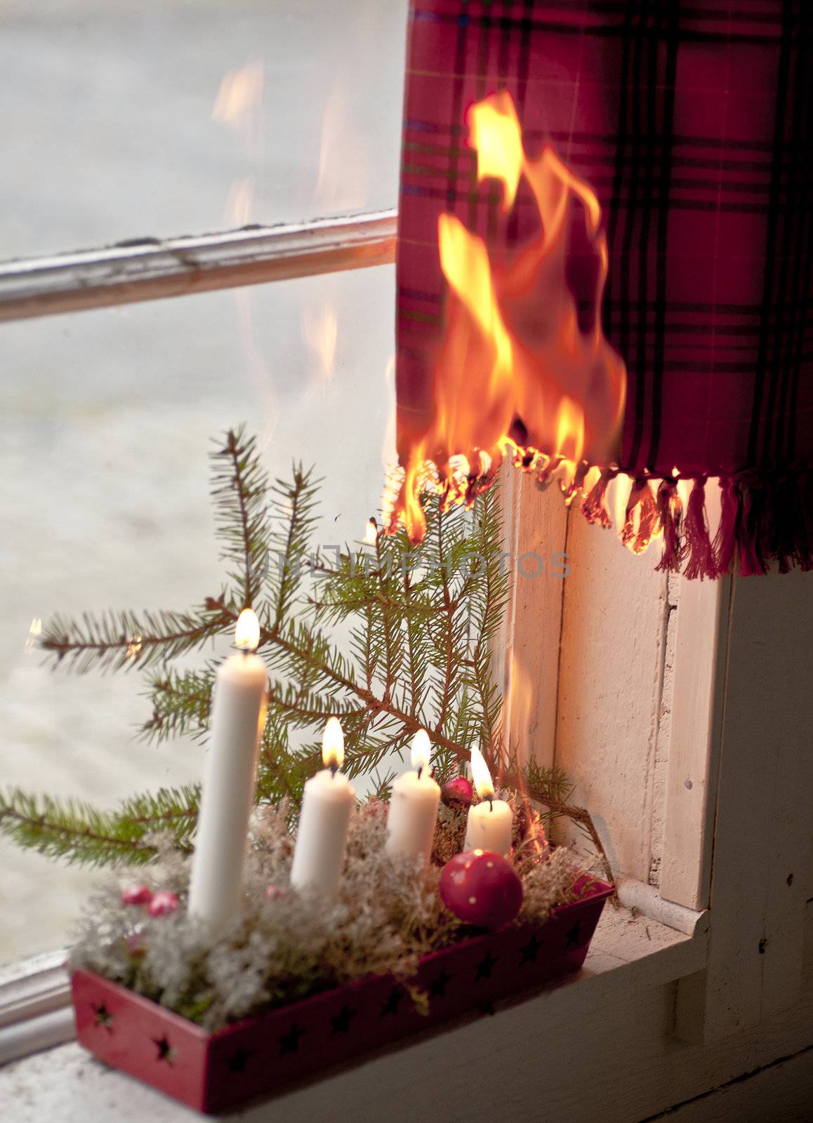 Advent candle wreath setting fire on a curtain