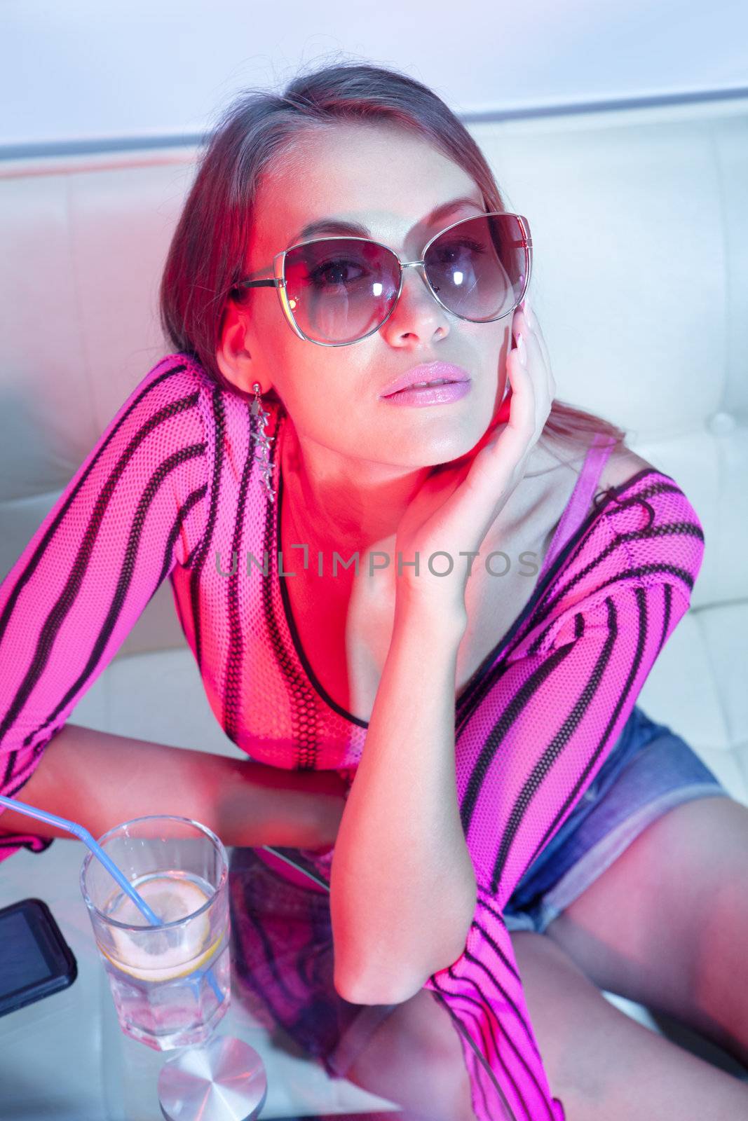 beautiful woman drinking cold cocktail in nightclub