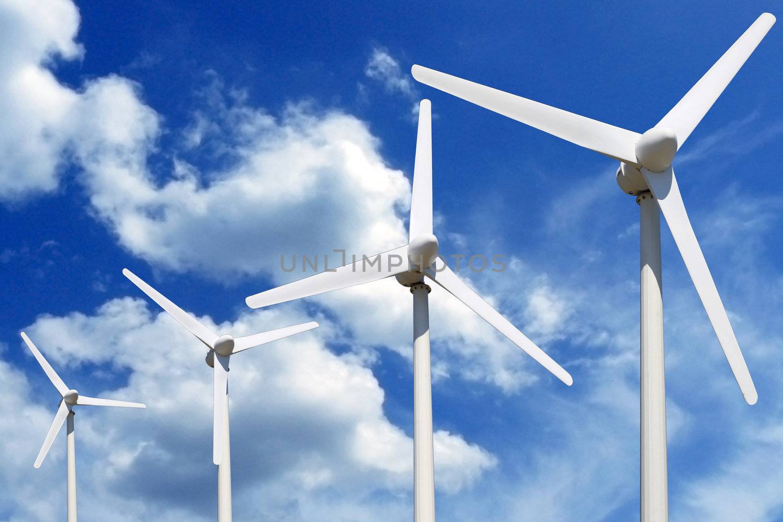 more wind turbines online blue sky with clouds