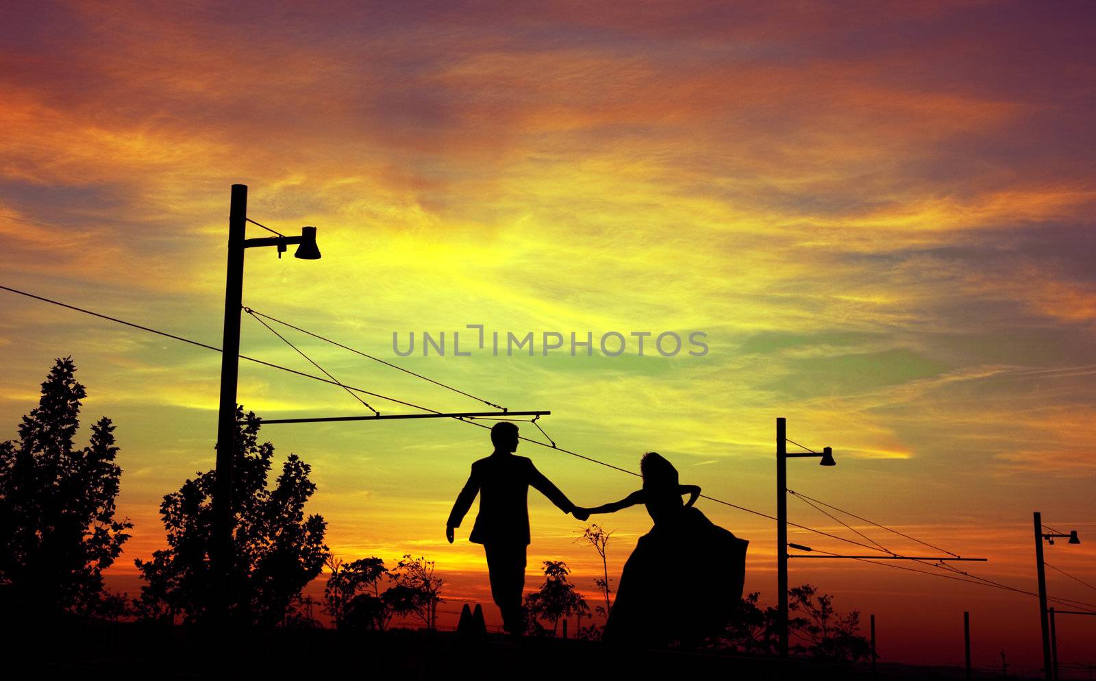 Sunset landscape and silhouettes of couple