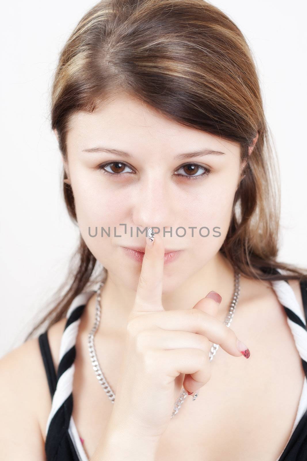 young blond/brunette women showing silence gesture, hand over mouth
