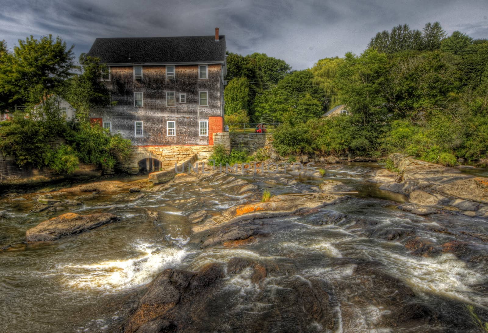 River flowing through a forest near old mill