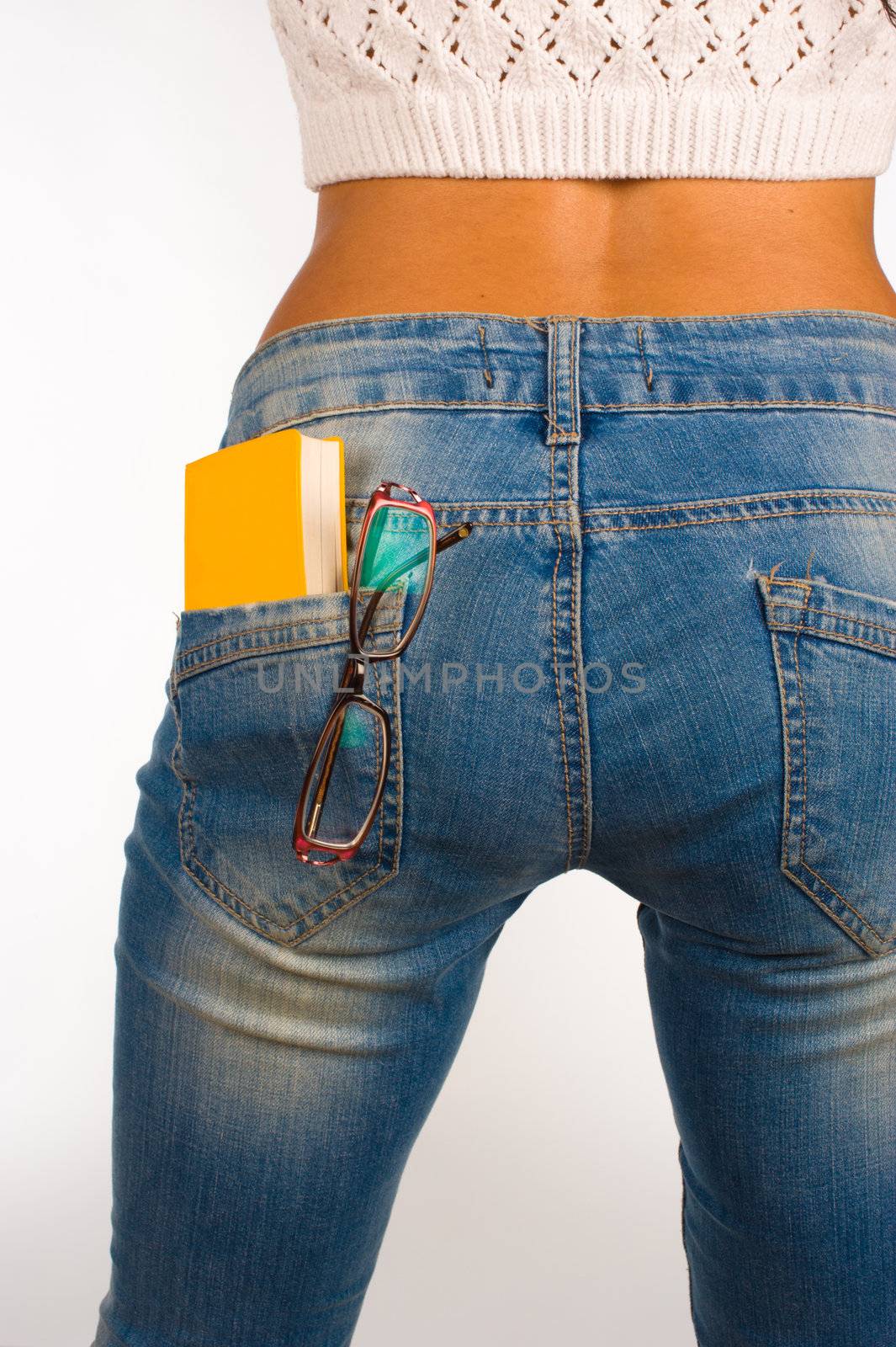 A small dictionary sticking out of  a sexy jeans back pocket