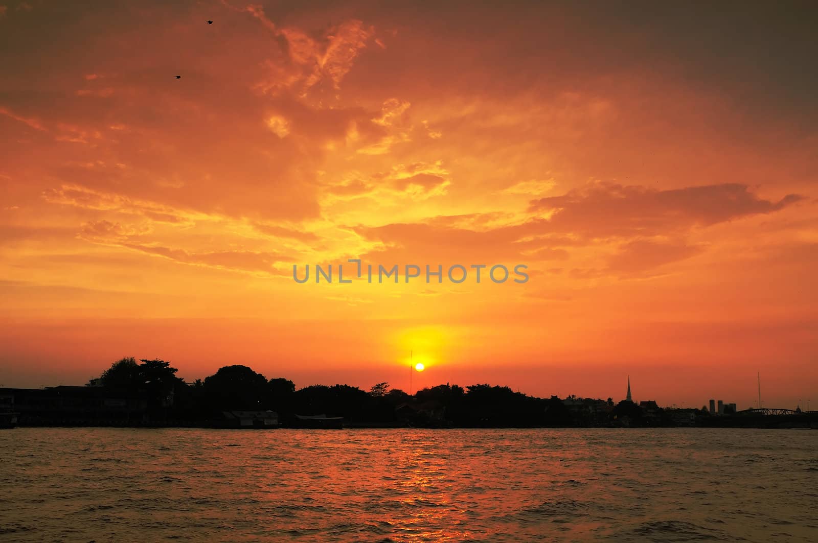 Sunset beside Chaopraya river at city of Bangkok, Thailand. 