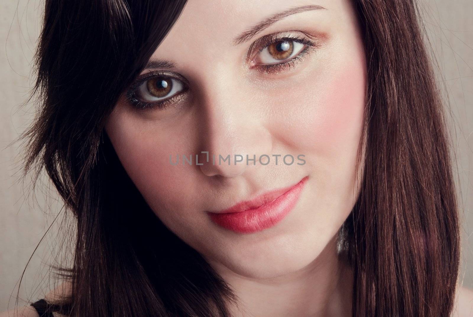Closeup portrait of beautiful bruntte. Studio shot