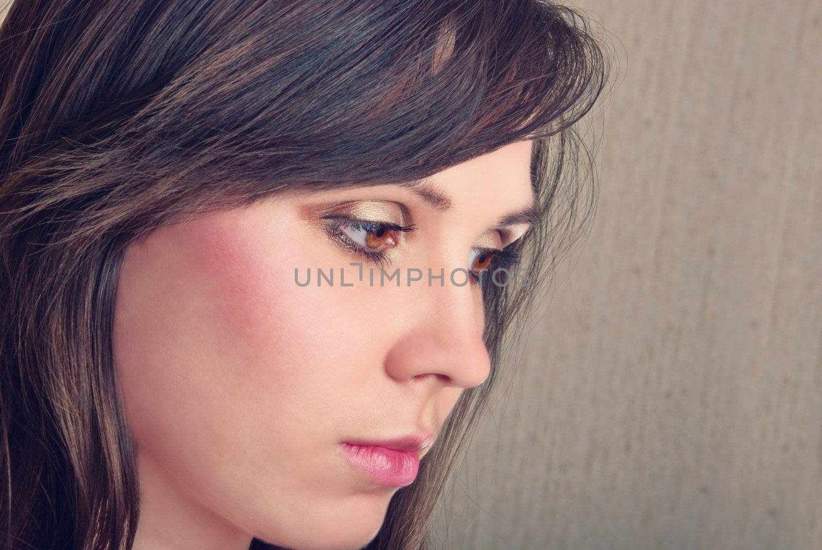 Closeup portrait of beautiful brunette. Studio shot