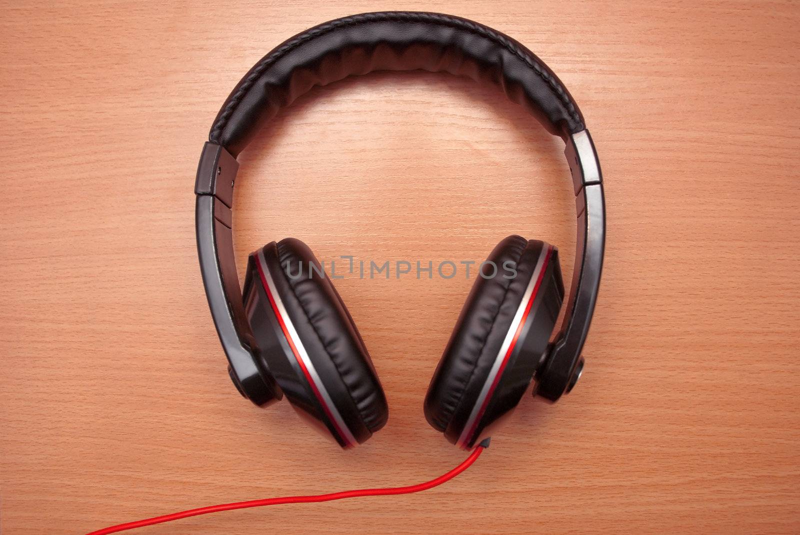 Stylish headphones on a wooden background.