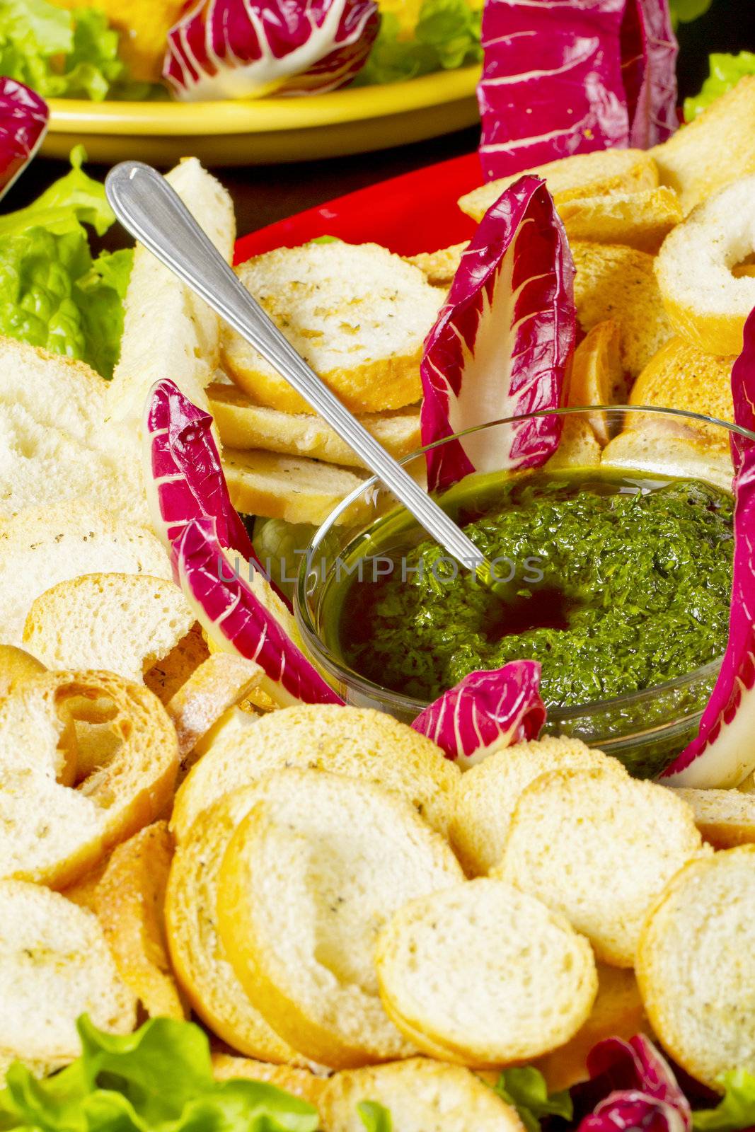 Cup full of "salsa verde" or "Bagnetto" in between slices of bread