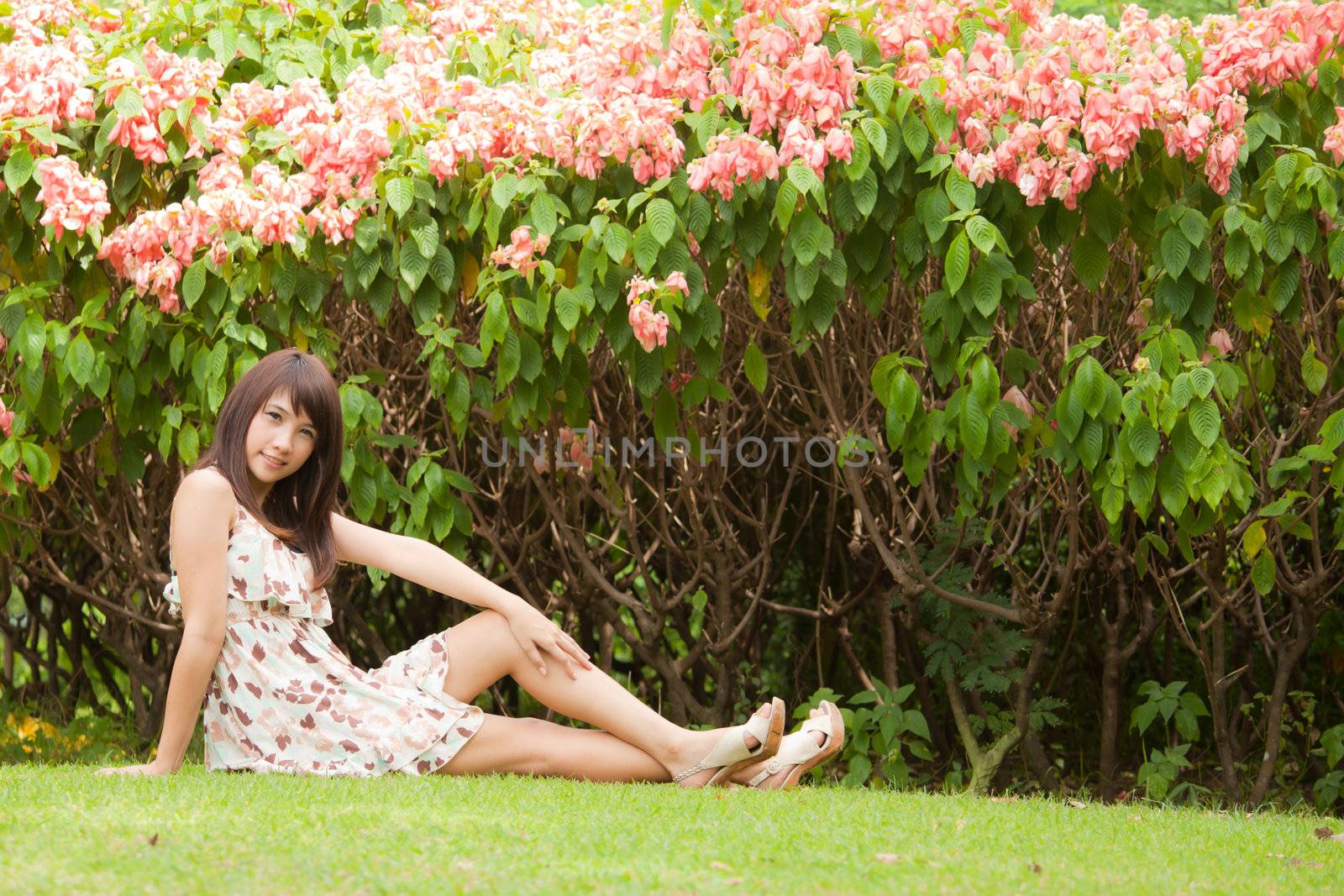 Cute beautyful asian girl portrait in the garden with flowers