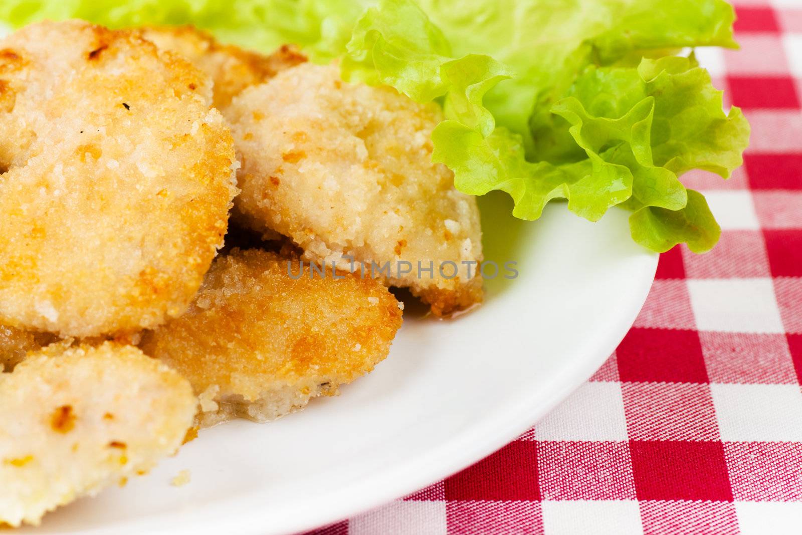 Cutlets and lettuce leaf on a white plate