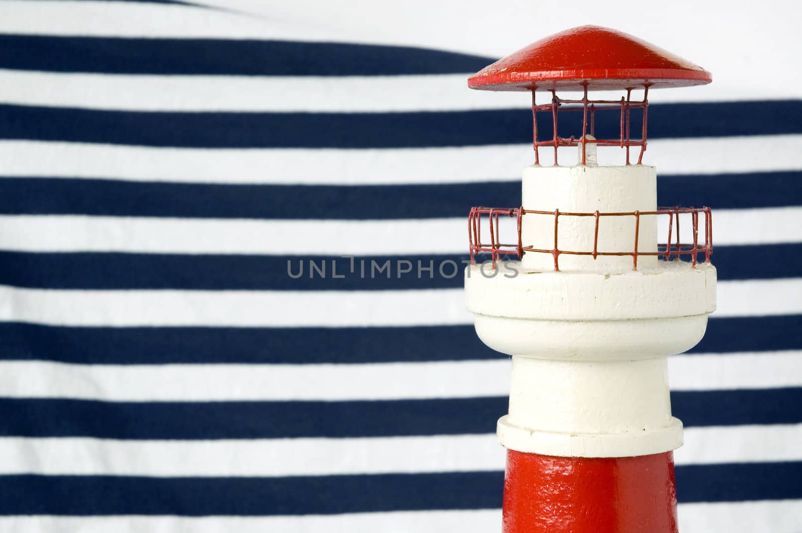 red lighthouse model with blue strips background