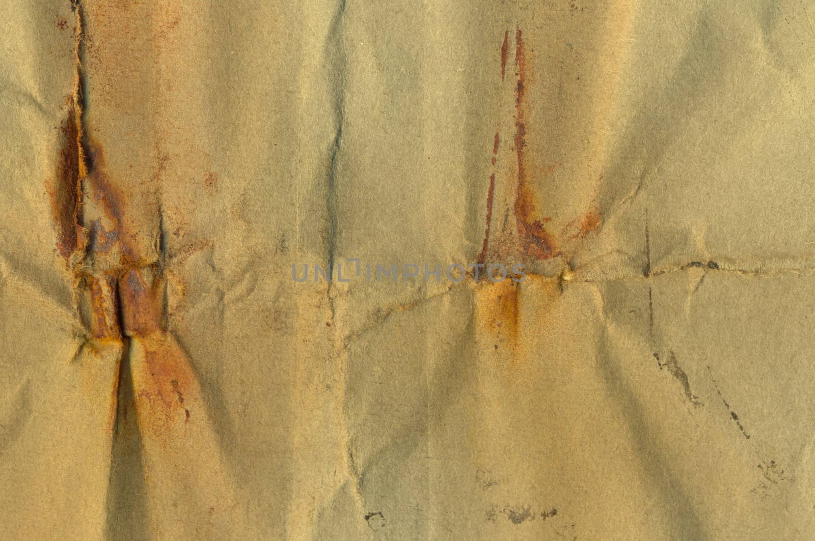 Weathered piece of paper with rust stains. Abstract grunge background.