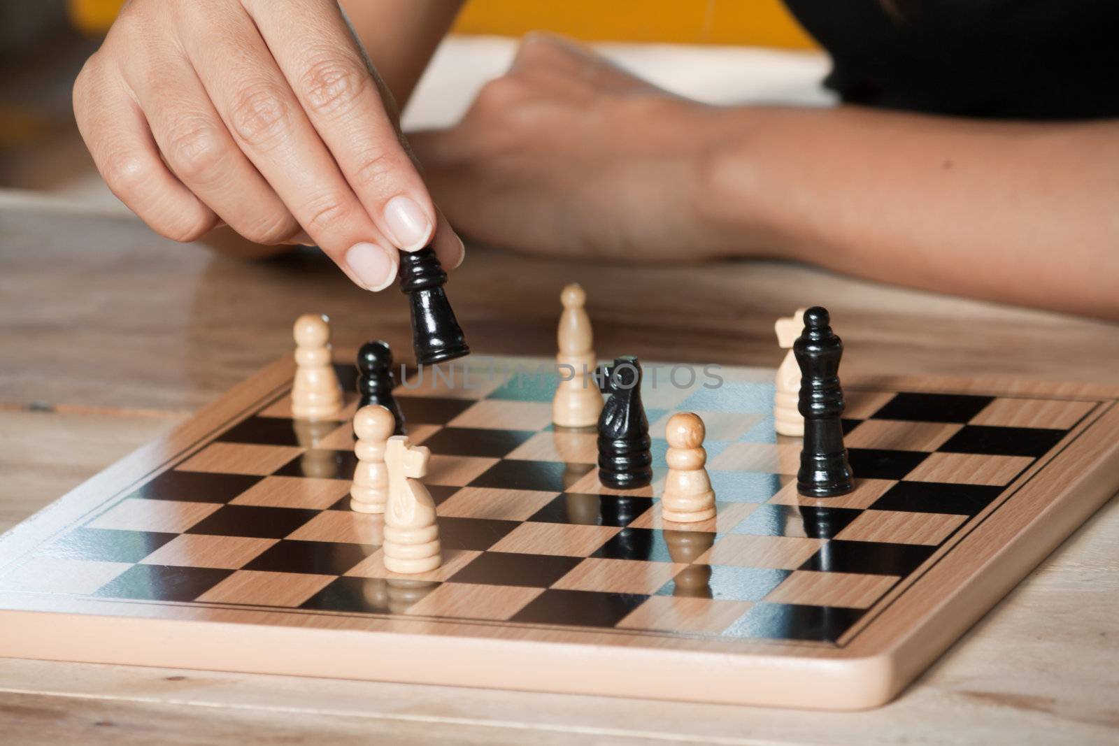 A piece of Chess in hand on the move