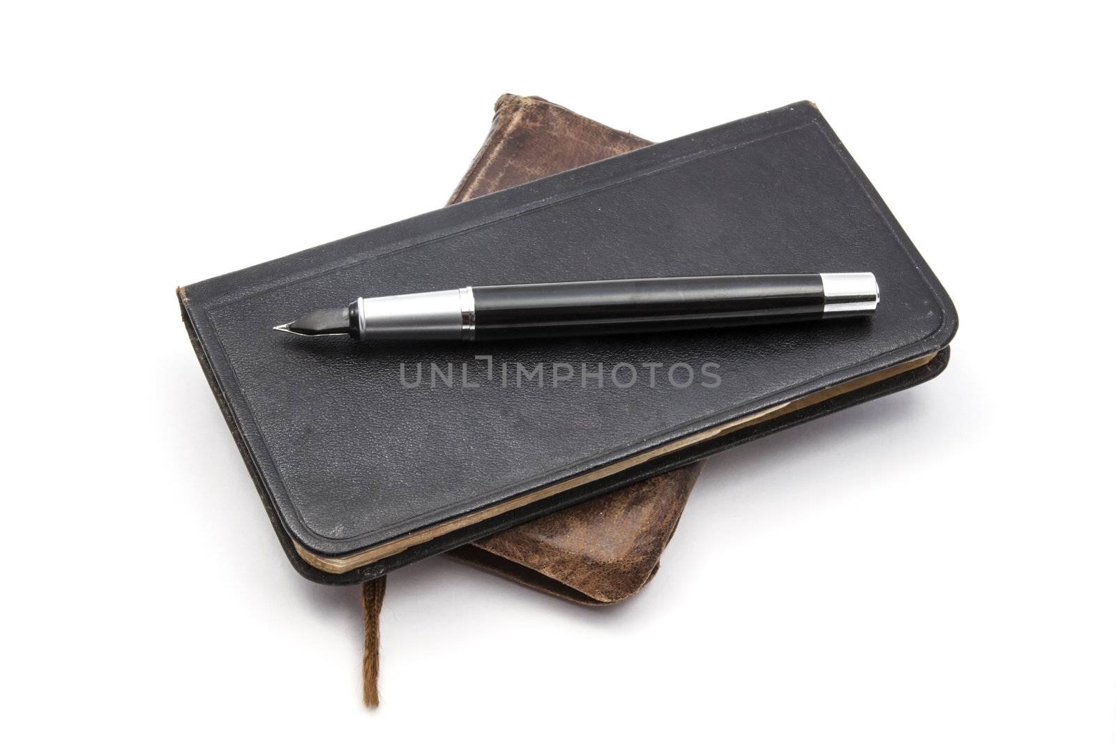 Old books and pen  isolated on white background