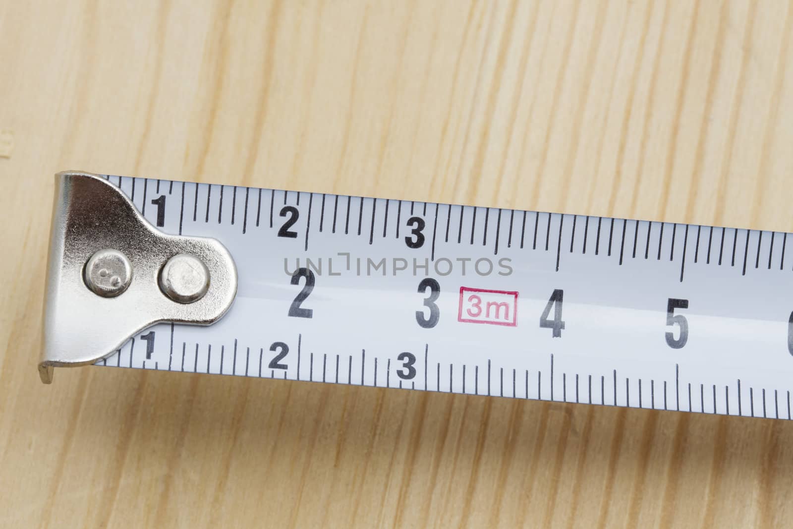 Tape measure closeup on wood background 