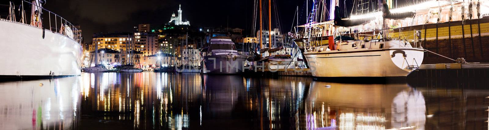 Marseille, France panorama at night. The famous european harbour view on the Notre Dame de la Garde