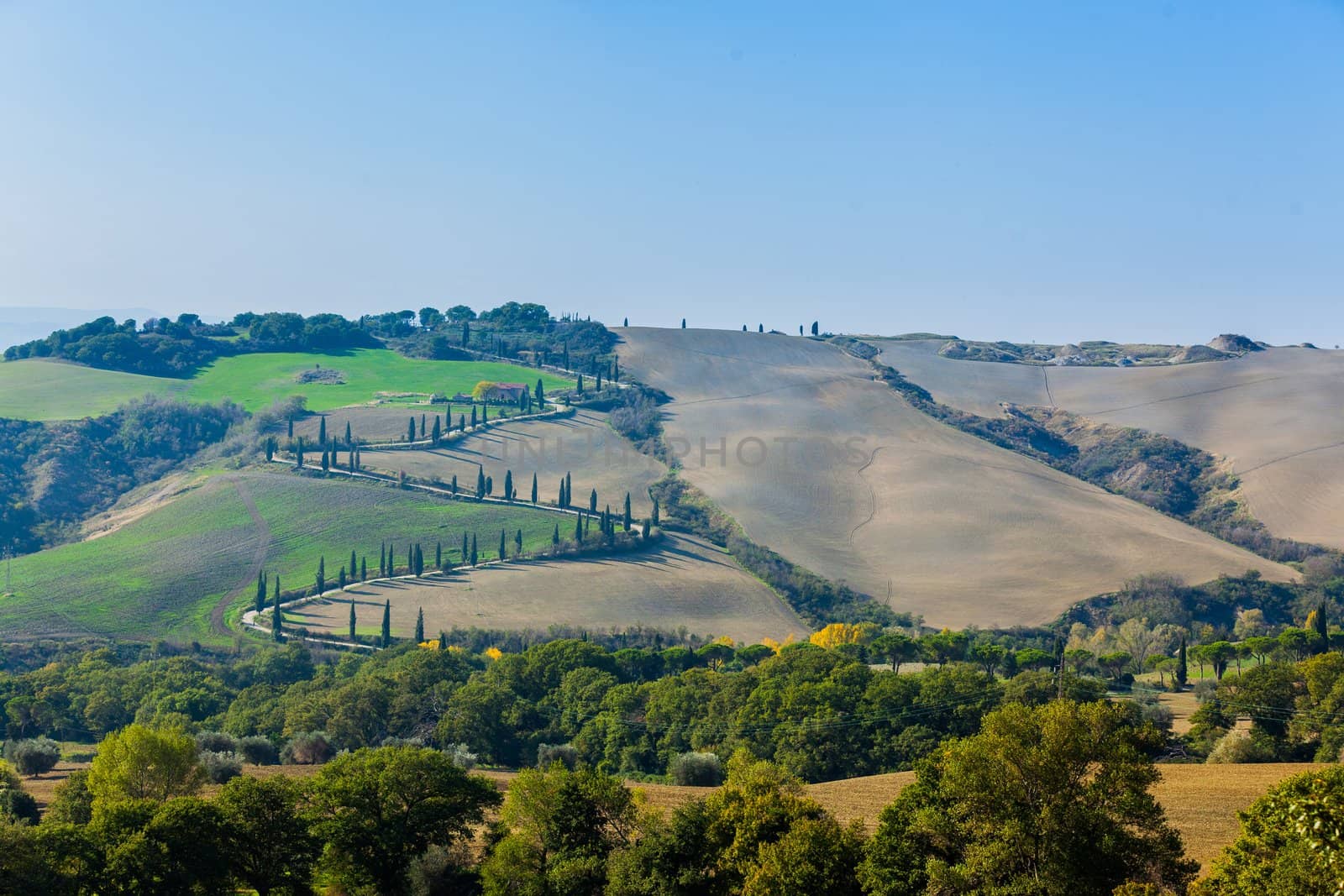 Typical beautiful Tuscan landscape-trees, grass, ski, villa. Italy