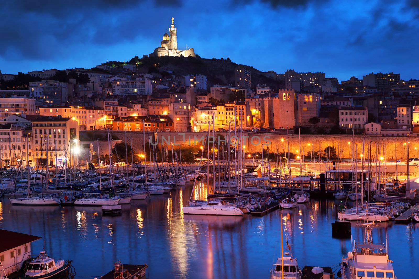 Marseille, France panorama at night. The famous european harbour view on the Notre Dame de la Garde