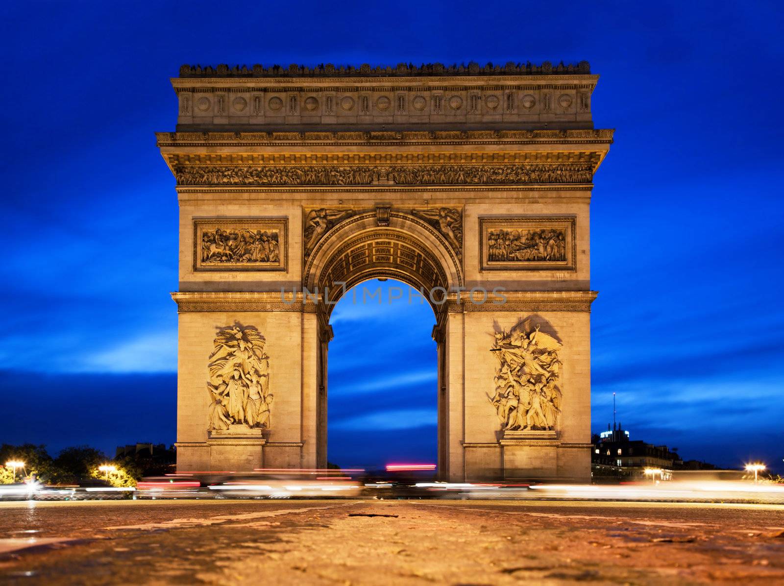 Arc de Triomphe, Paris, France at night. View from Avenue des Champs-Elysees
