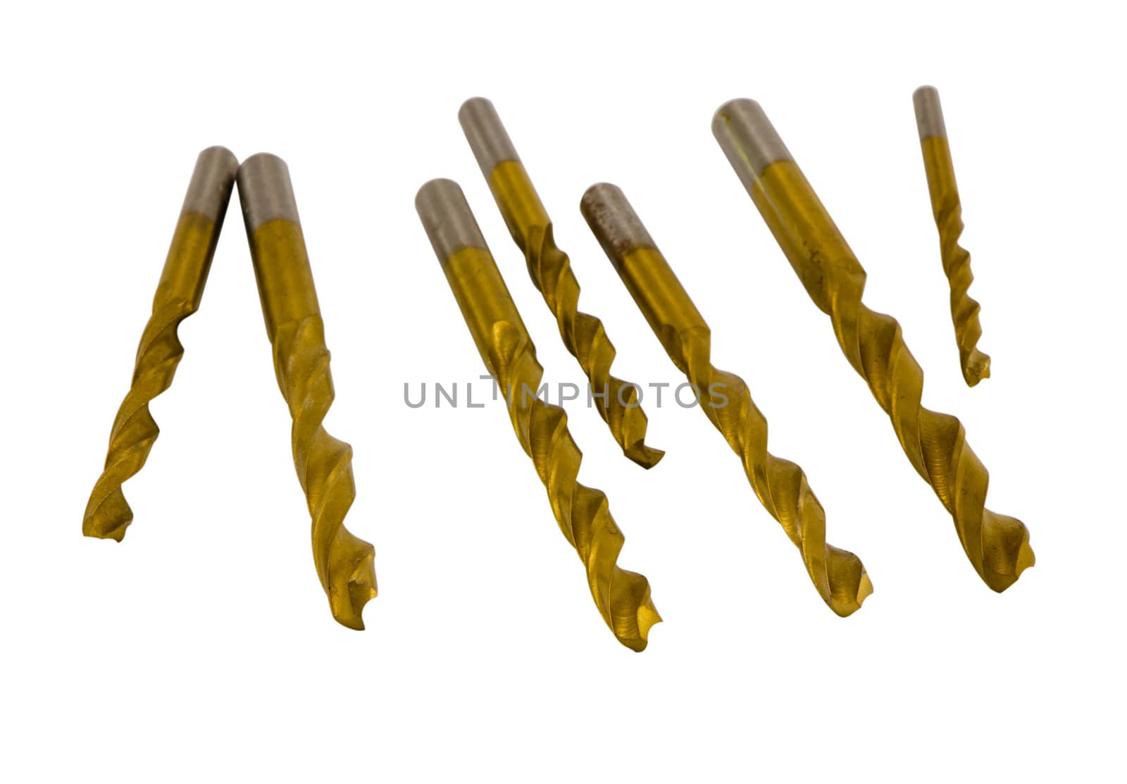 Various size golden drill bits isolated on white background