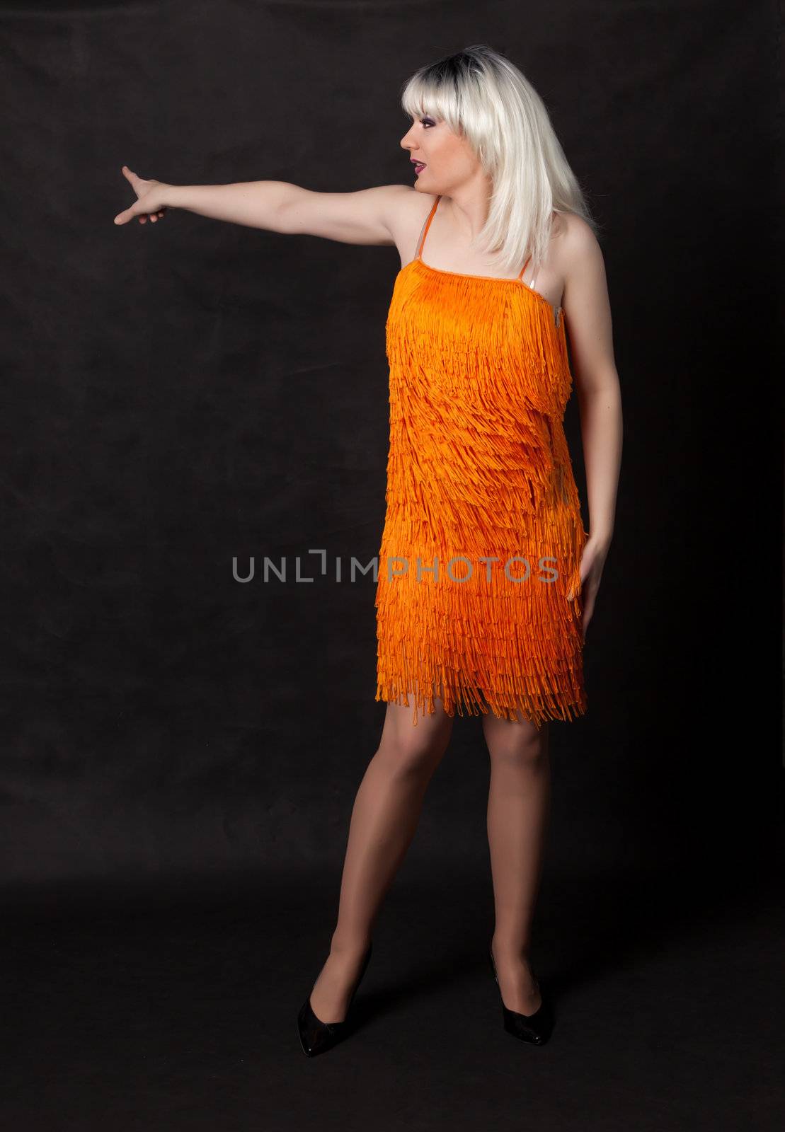 Full length portrait of drag queen. Man dressed as Woman, on black background