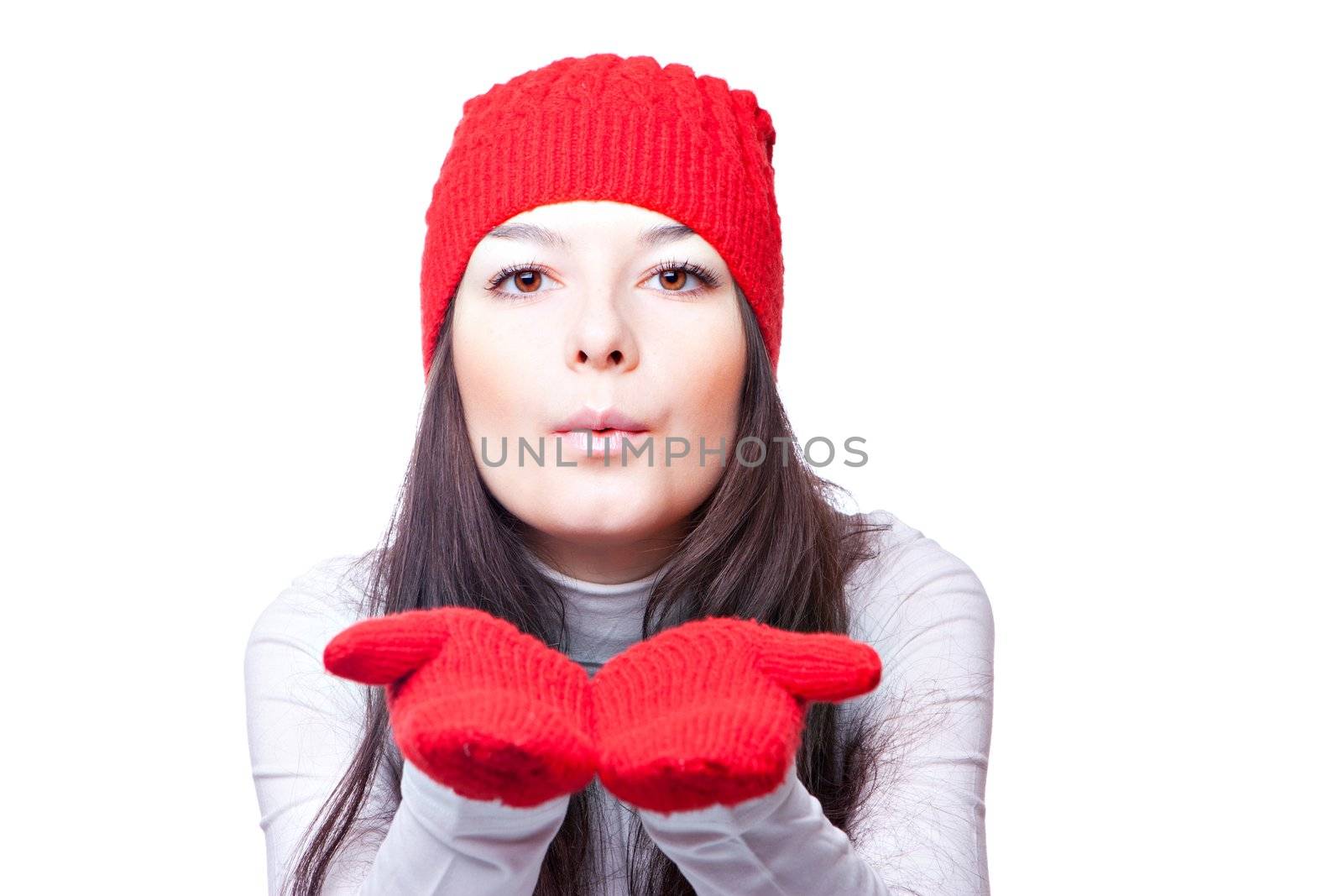 a woman in a red cap blows isolated on white background