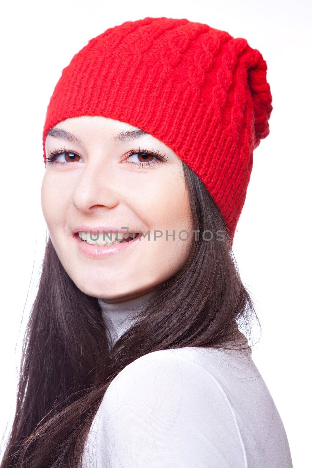 the face of a beautiful girl in a red cap