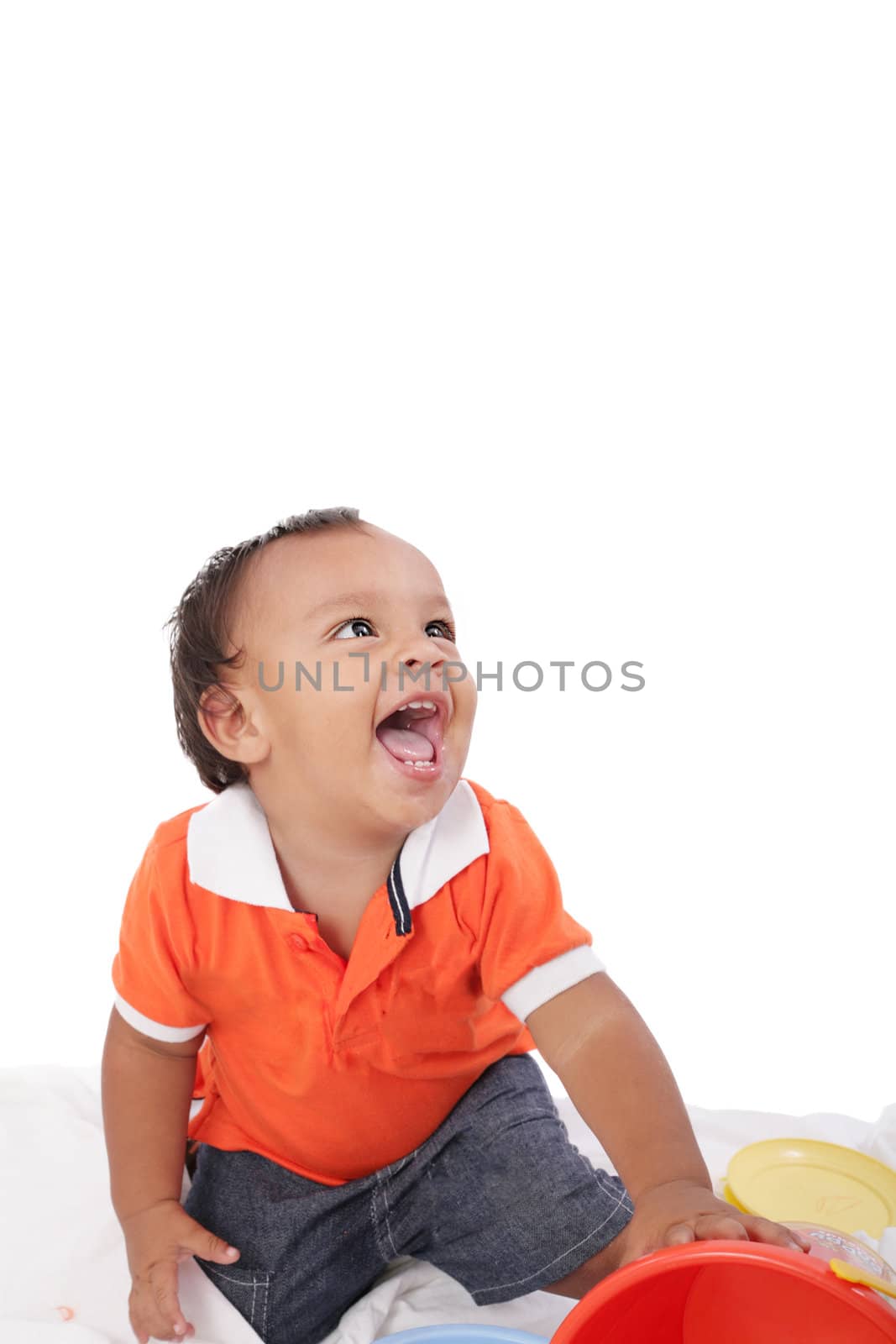 Adorable 1 year old hispanic boy with a big smile looking up