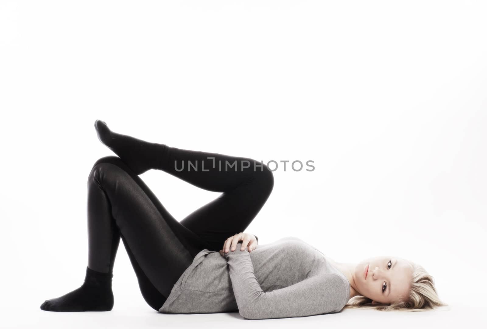 slim girl lying on white