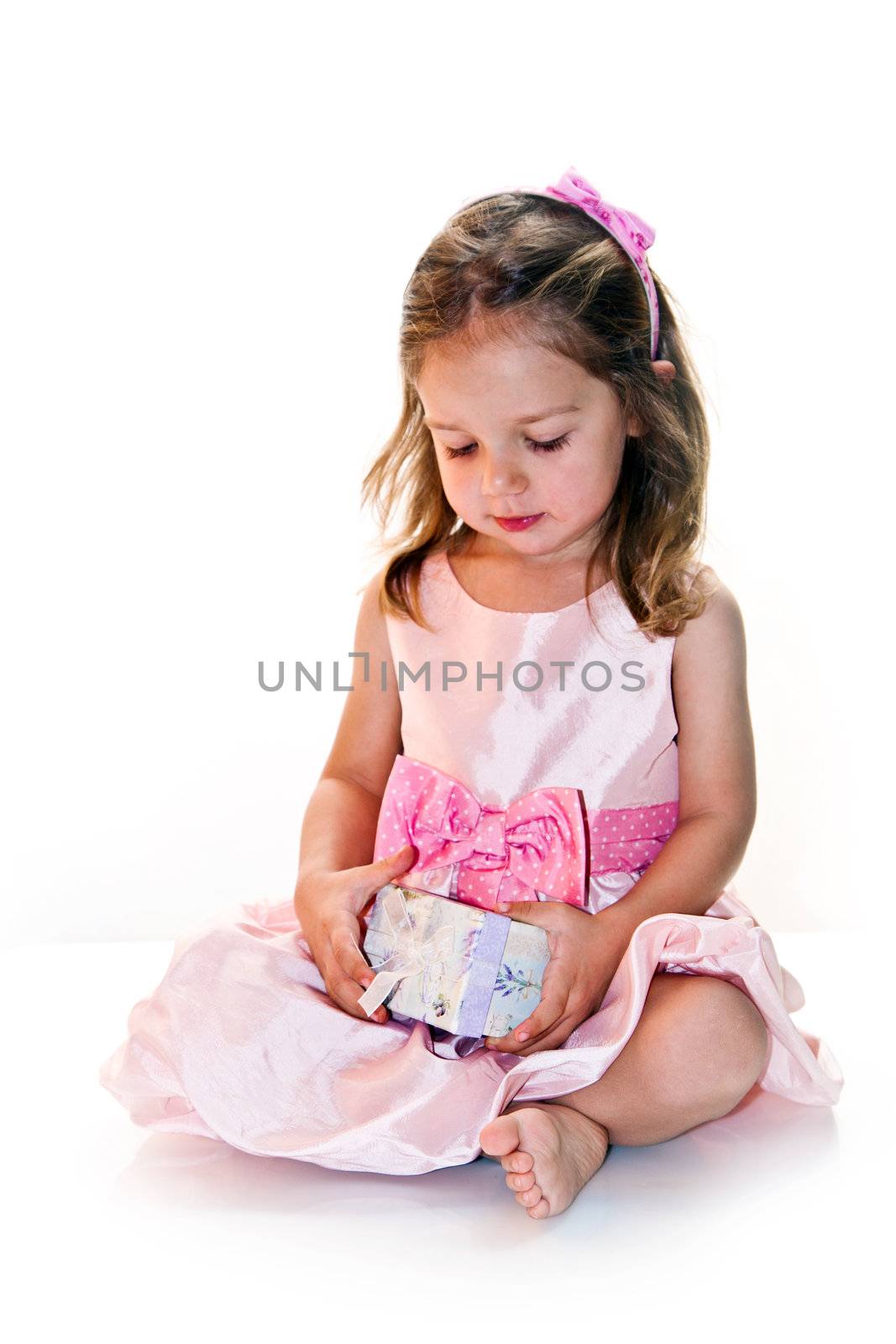 Joyful little girl holding lilac present in hands