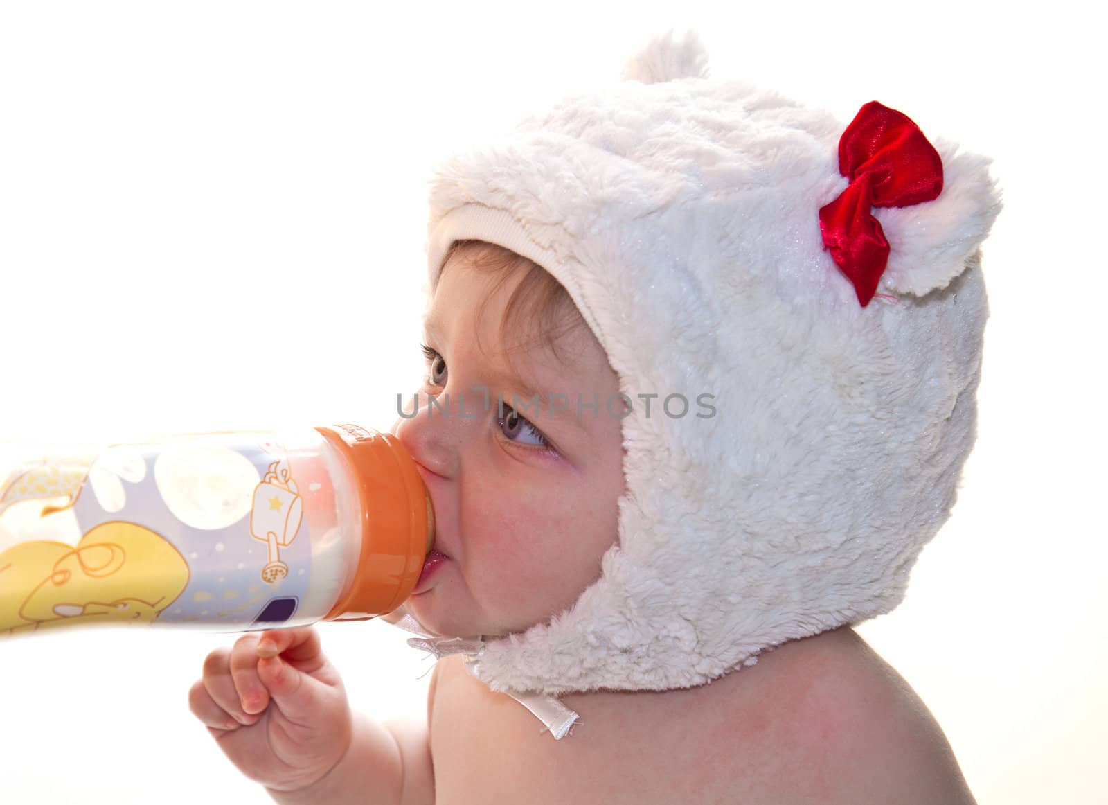 Pretty baby girl drinking milk from bottle  by lsantilli