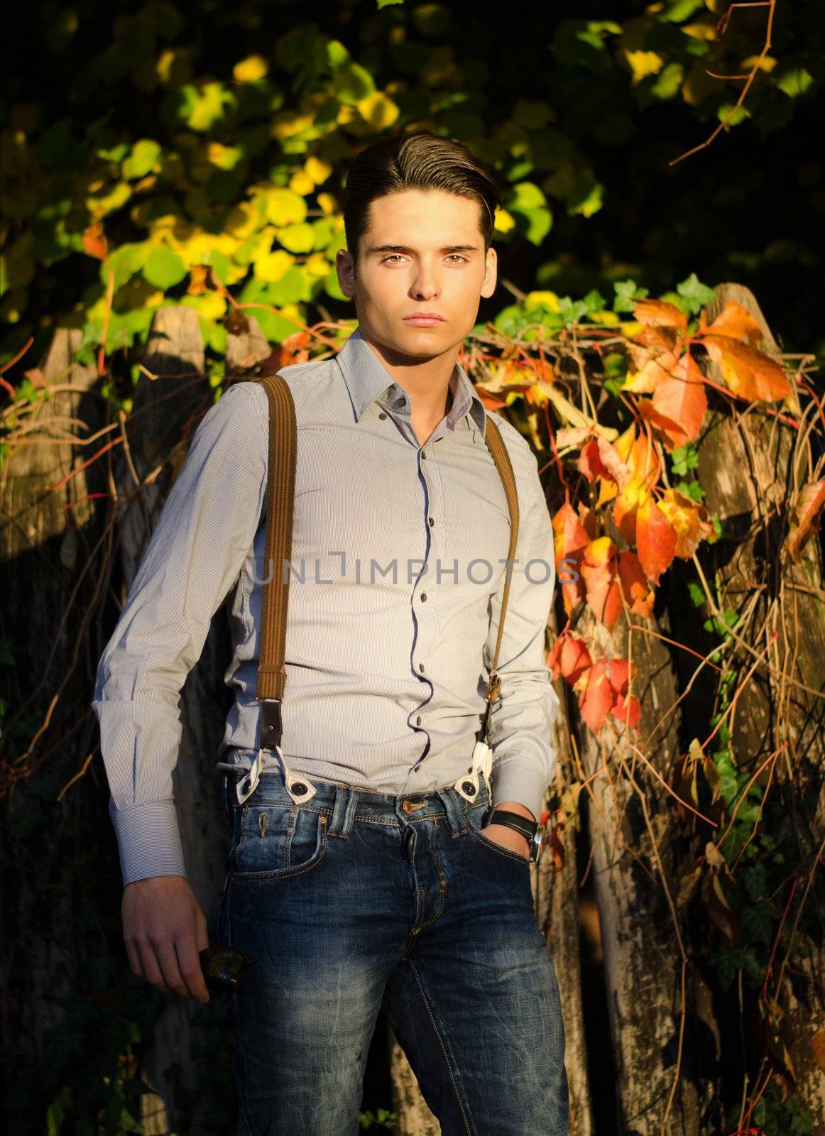 Attractive young male model outdoors in nature in beautiful sunset light