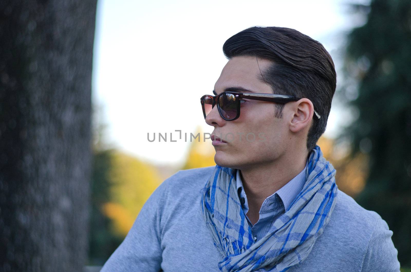 Good looking young man in evening light, during fall season by artofphoto