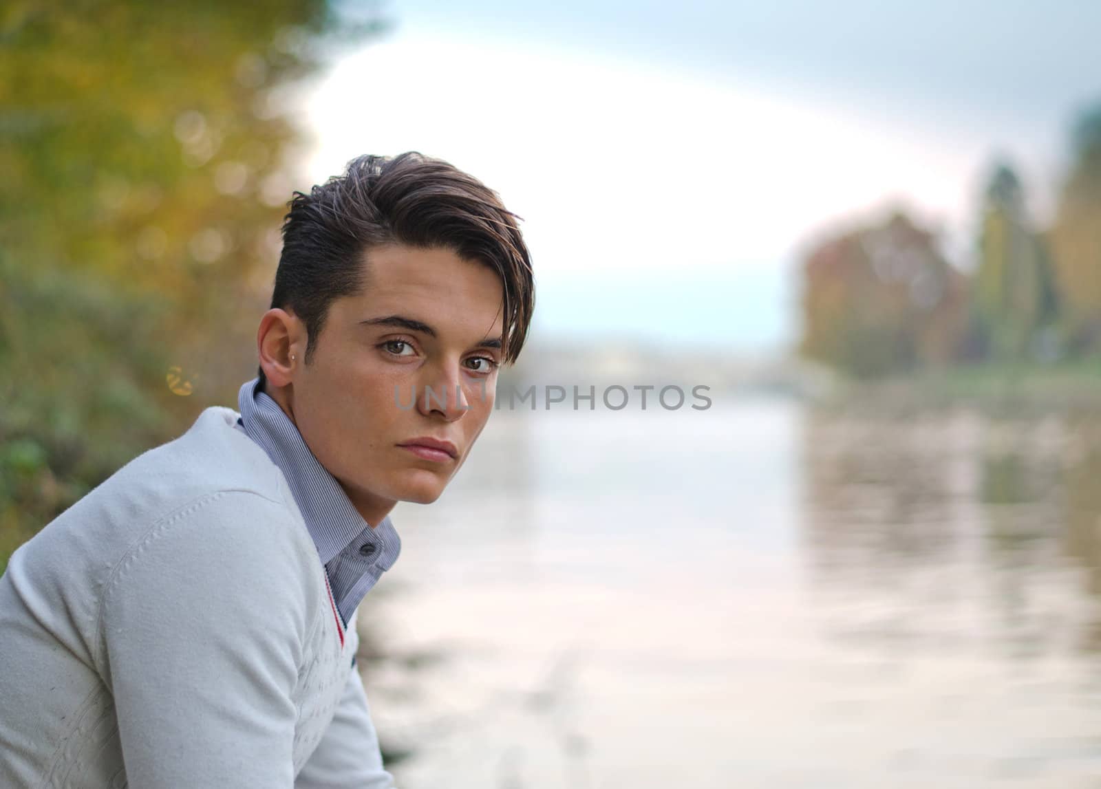 Portrait of handsome young male model on river banks by artofphoto