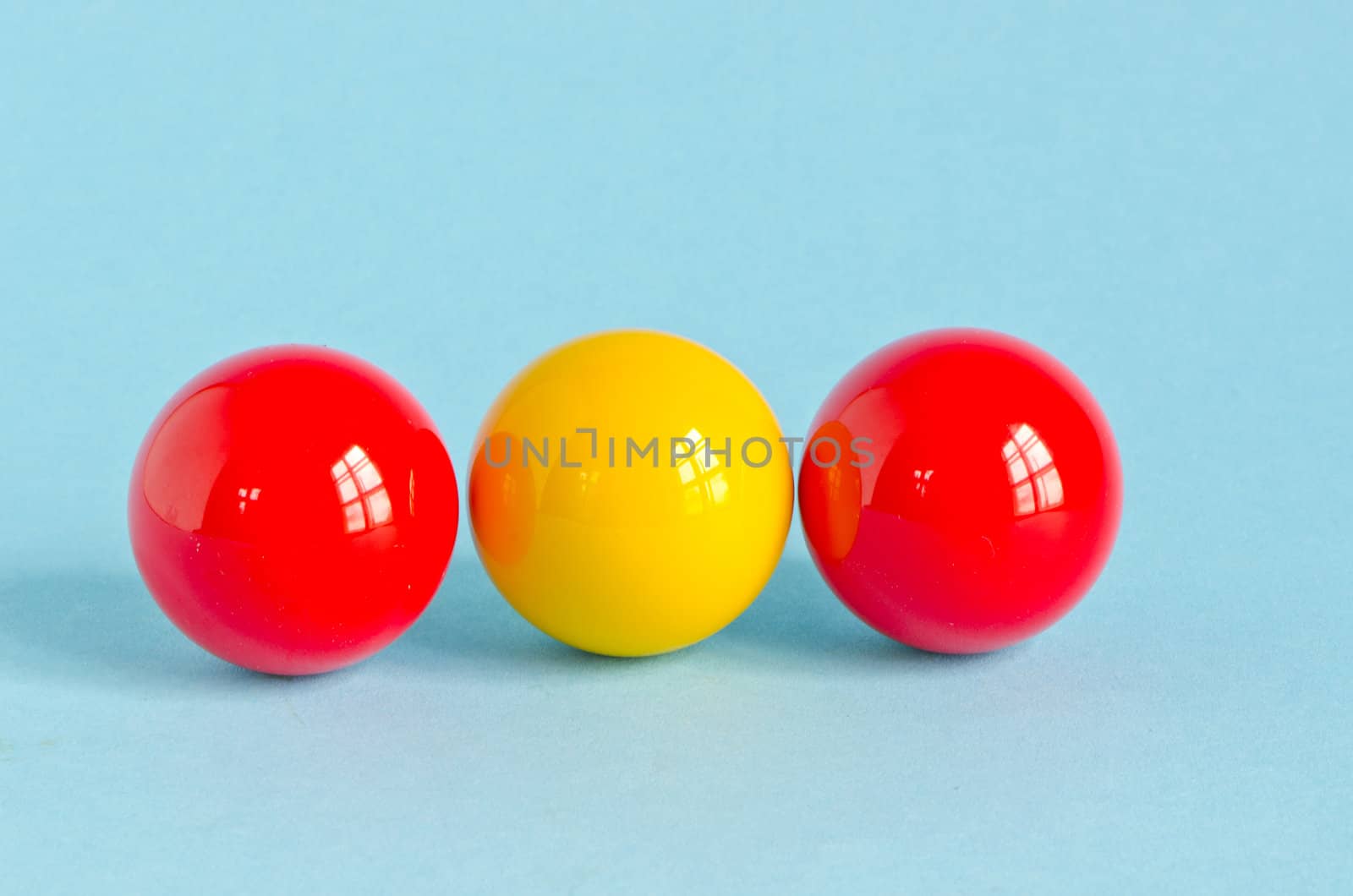 three colorful billiards balls on azure background