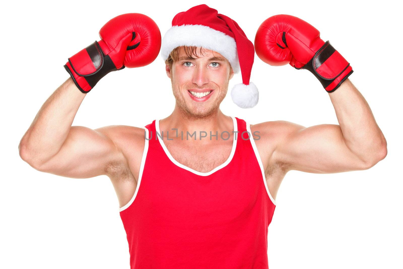 Christmas fitness boxer wearing santa hat smiling happy. Funny portrait of fit exercise model isolated on white background.