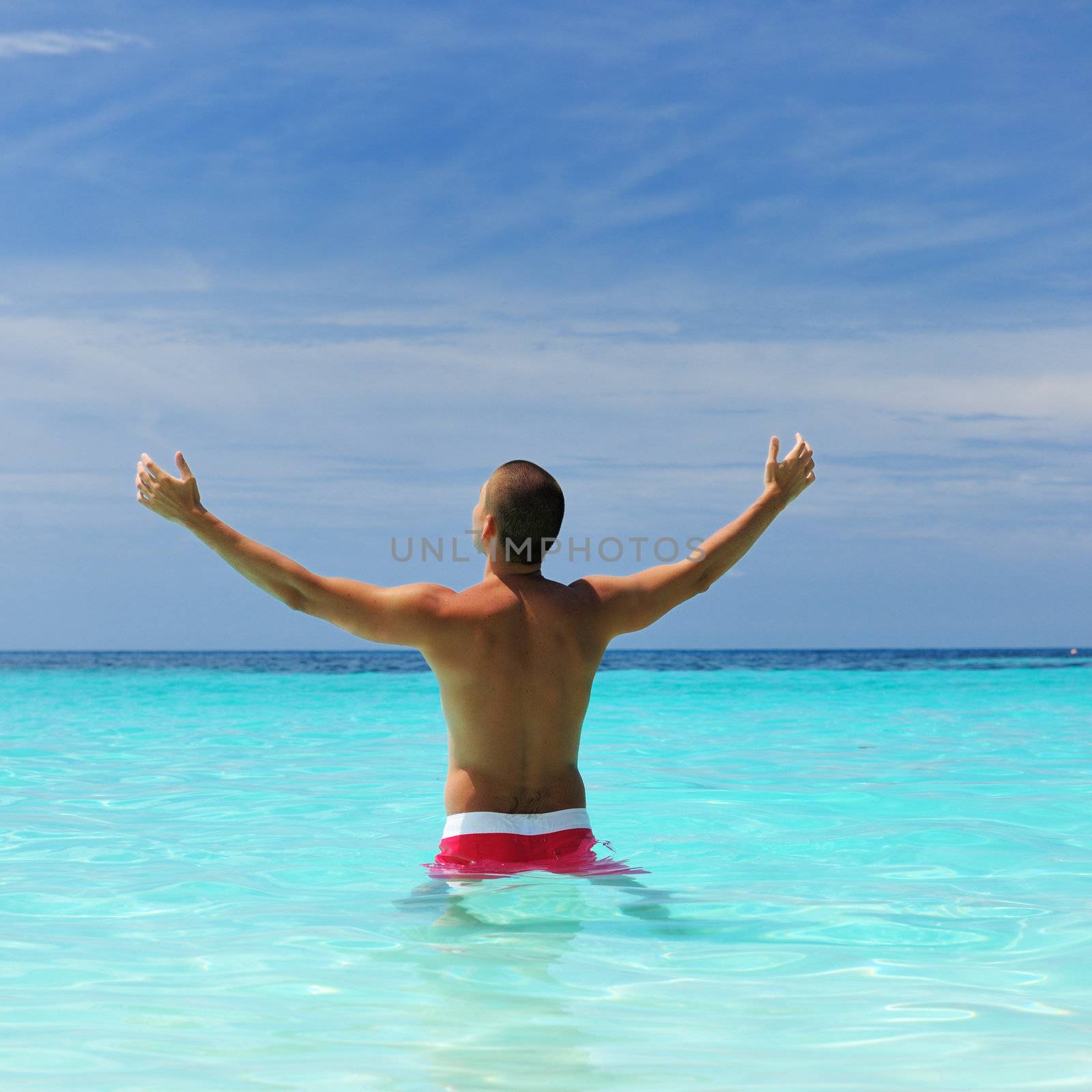 Man in water at tropical beach