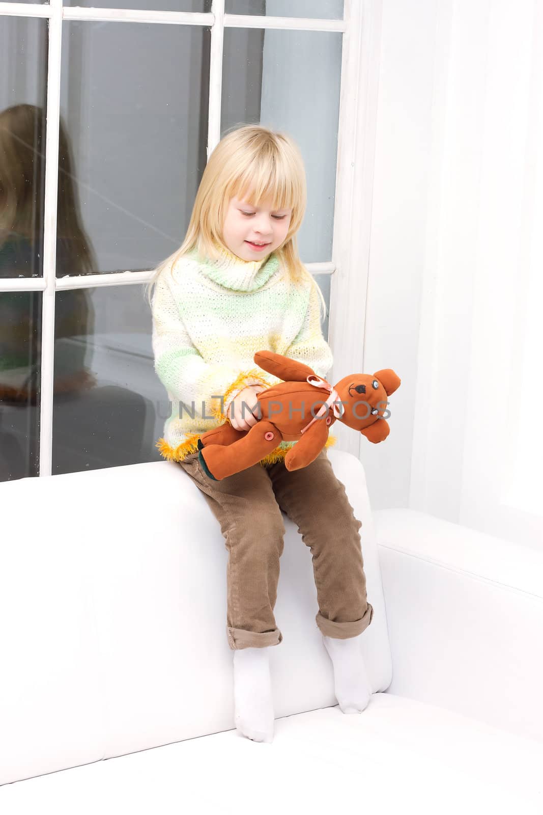 little girl with a teddy bear brown