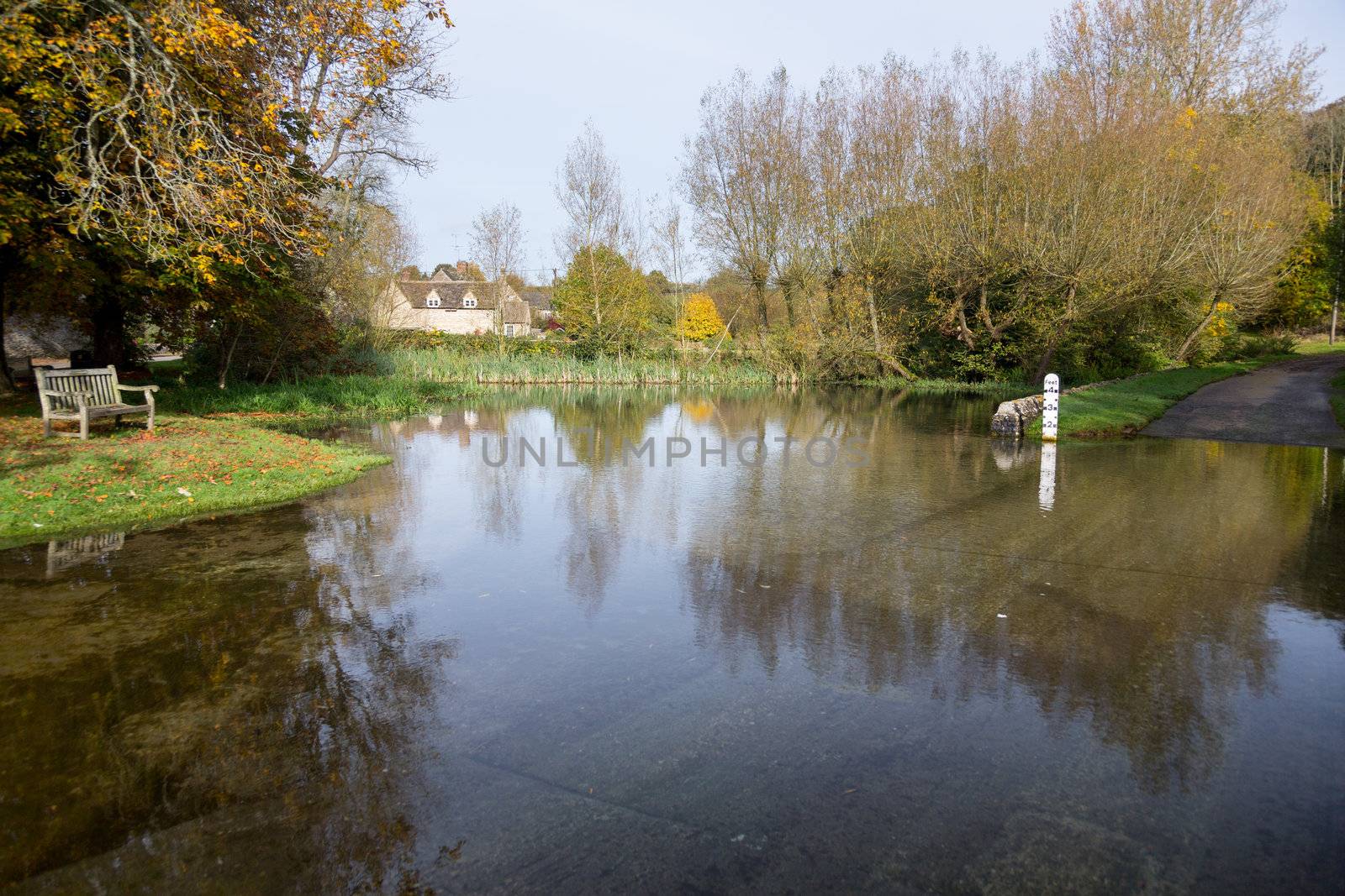 Seat overlooking a deep river at road ford on Shill Brook at Shilton Oxfordshire