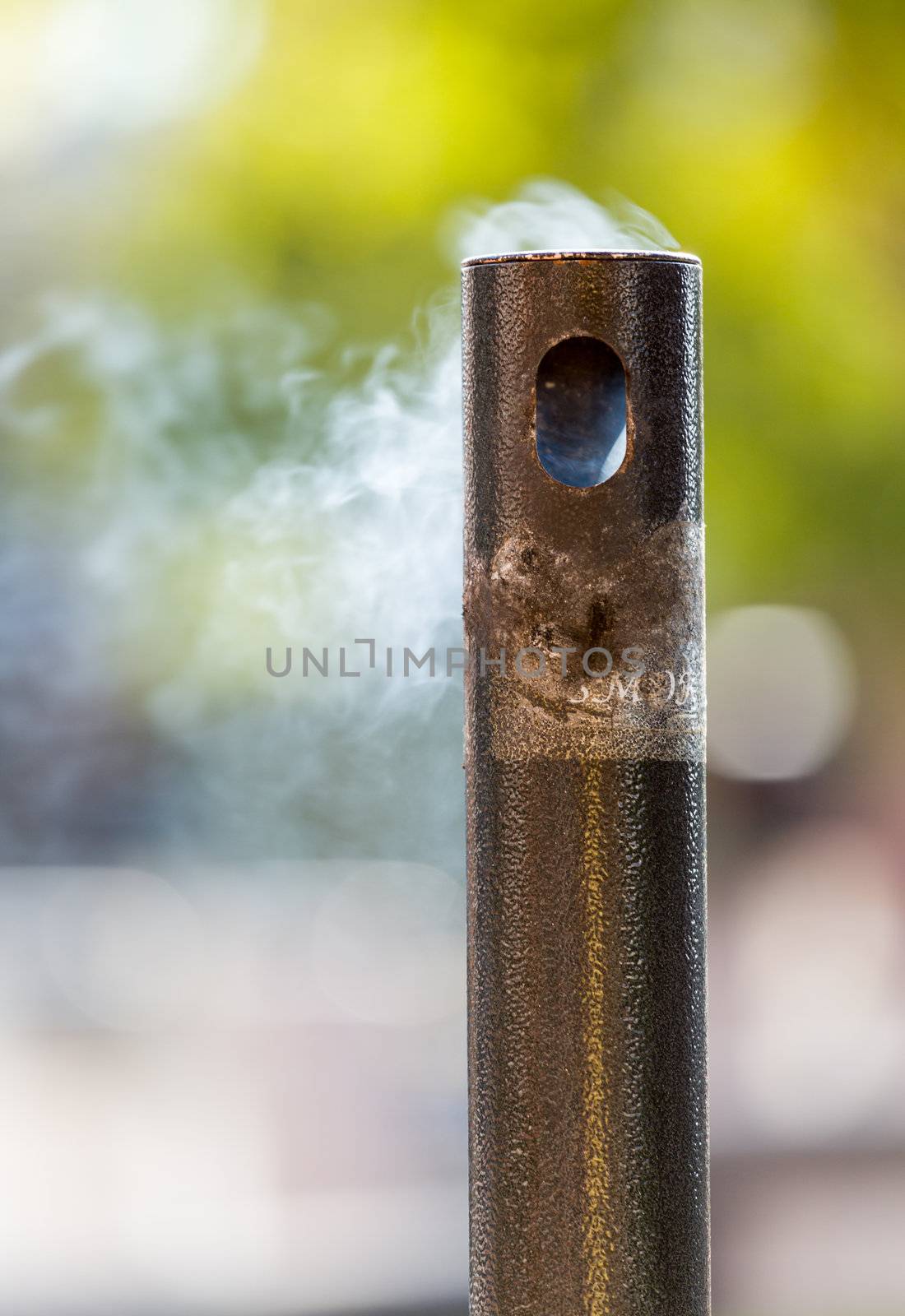 Smoke from cigarettes still burning in waste disposal unit