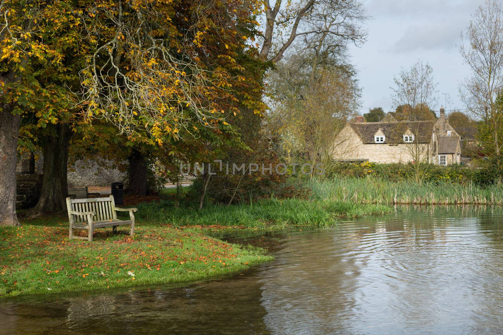 Seat overlooking a deep river at road ford on Shill Brook at Shilton Oxfordshire