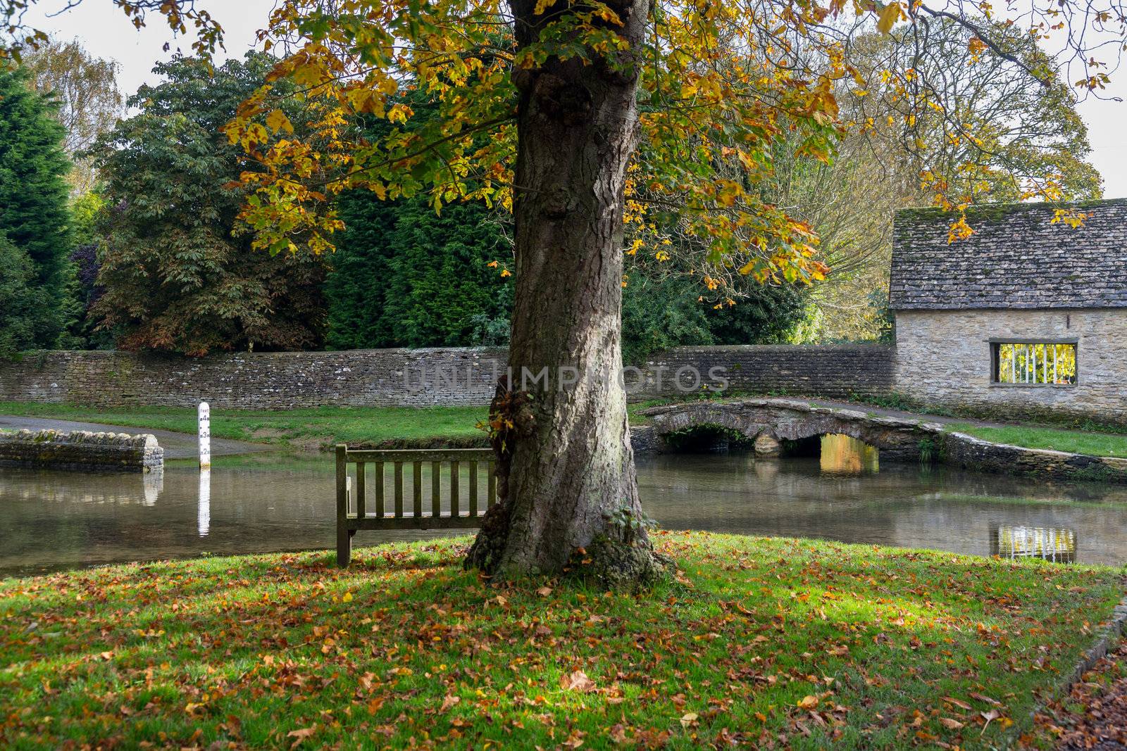 Seat overlooking a deep river at road ford on Shill Brook at Shilton Oxfordshire