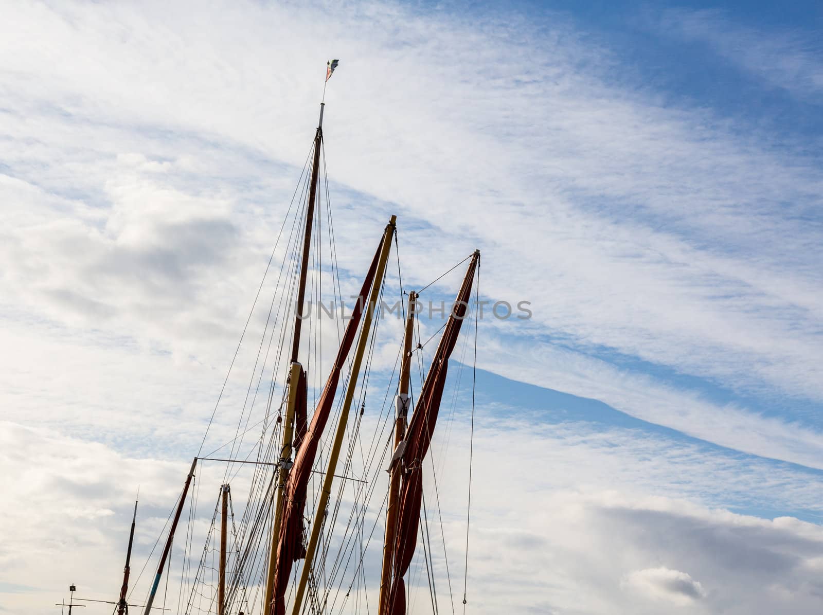 Thames sailing ship or barge with masts and sails by dock in Faversham Kent UK