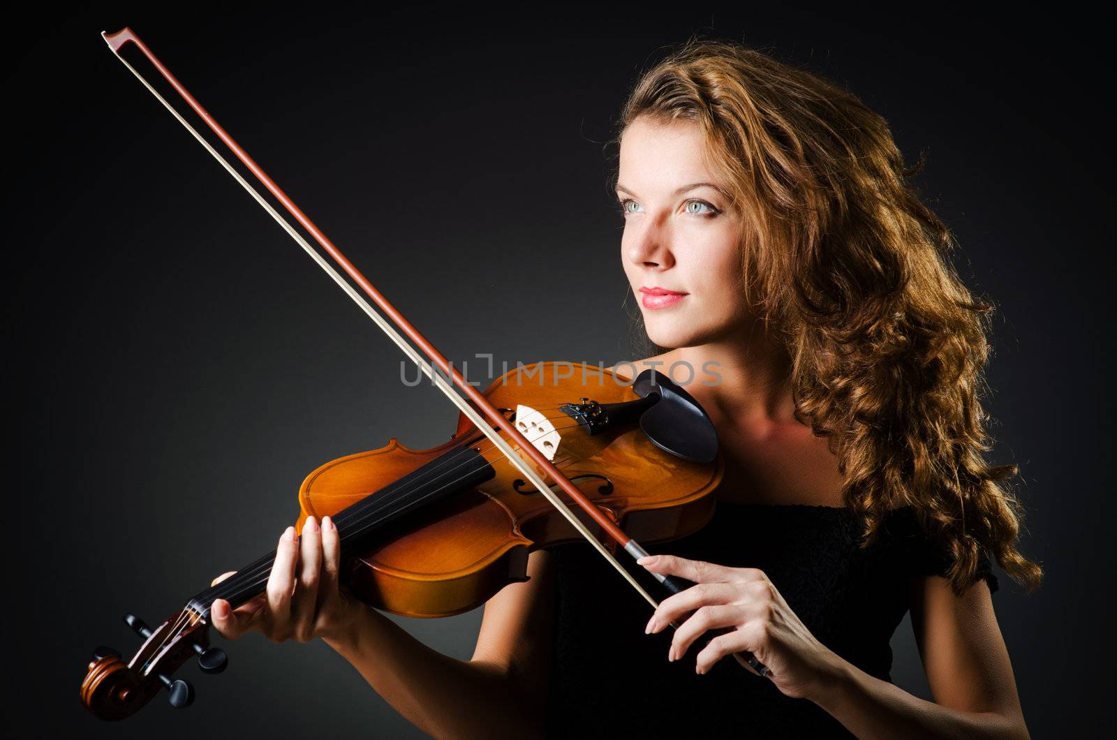 Woman with violin in dark room by Elnur