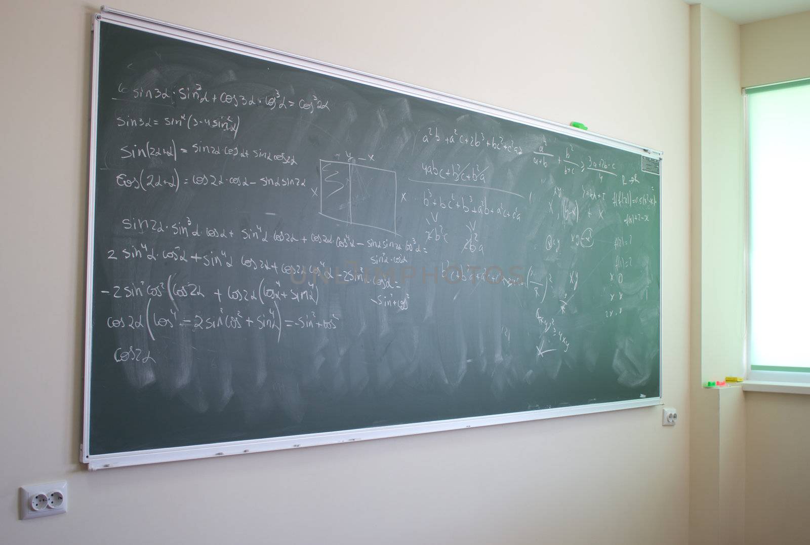 Blackboard with mathematical formulas in a modern classroom